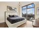 Stylish bedroom with a large window offering city views, complemented by hardwood floors at 270 17Th Nw St # 1113, Atlanta, GA 30363