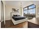 Light-filled bedroom with modern decor and a fantastic city view from a large window at 270 17Th Nw St # 1113, Atlanta, GA 30363