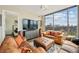 Comfortable living room with leather sofas, ottoman, and city views at 270 17Th Nw St # 1113, Atlanta, GA 30363