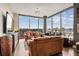 Bright living room with hardwood floors, leather couches and a stunning cityscape view through large windows at 270 17Th Nw St # 1113, Atlanta, GA 30363