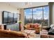 Inviting living room featuring brown leather furniture and expansive windows with skyline views at 270 17Th Nw St # 1113, Atlanta, GA 30363