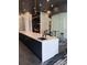 Modern kitchen with an island, sink, white countertops, and elegant lighting fixtures at 3324 Peachtree Ne Rd # 1116, Atlanta, GA 30326