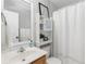 Cozy bathroom featuring a sink, toilet, shower with a curtain, and decorative storage at 503 Stanford Pl, Woodstock, GA 30188