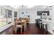 Bright dining area with large windows and modern lighting adjacent to the kitchen, perfect for Gathering meals at 503 Stanford Pl, Woodstock, GA 30188