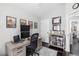 Bright home office featuring a desk, dual monitors, and a decorative bookshelf display at 503 Stanford Pl, Woodstock, GA 30188