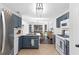 Kitchen connects seamlessly to the dining room, with stainless appliances and a modern aesthetic at 503 Stanford Pl, Woodstock, GA 30188