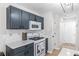 Modern kitchen with stainless steel appliances, quartz countertops, and stylish cabinetry at 503 Stanford Pl, Woodstock, GA 30188