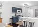 Modern kitchen featuring a breakfast bar, stainless steel appliances, and elegant lighting at 503 Stanford Pl, Woodstock, GA 30188