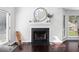 Bright living room featuring a cozy fireplace and decorative mirror perfect for gatherings at 503 Stanford Pl, Woodstock, GA 30188