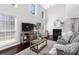 Light-filled living room features a fireplace, high ceilings, and a seamless flow to the outdoors at 503 Stanford Pl, Woodstock, GA 30188