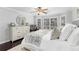 Comfortable main bedroom with a large dresser, neutral colors, and natural light from bay windows at 503 Stanford Pl, Woodstock, GA 30188