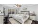 Bright main bedroom with bay windows, a ceiling fan, and a plush bed with patterned pillows at 503 Stanford Pl, Woodstock, GA 30188