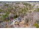 Overhead shot displays the house nestled within a serene, wooded landscape at 5515 Punkintown Rd, Douglasville, GA 30135