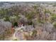 Aerial view showcasing the home nestled among lush, mature trees at 5515 Punkintown Rd, Douglasville, GA 30135