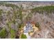 An aerial shot showcasing the house nestled among trees with a long private driveway at 5515 Punkintown Rd, Douglasville, GA 30135