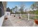 Wooden back deck with white railing and distant trees at 5515 Punkintown Rd, Douglasville, GA 30135