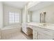 Bright bathroom featuring double sinks, white cabinetry, and a relaxing soaking tub at 5515 Punkintown Rd, Douglasville, GA 30135