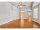 Bedroom with hardwood floors, neutral paint, closet and views into other rooms at 5515 Punkintown Rd, Douglasville, GA 30135