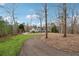 Long driveway leads to a white home surrounded by wooded scenery at 5515 Punkintown Rd, Douglasville, GA 30135