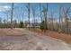 Scenic view of a long, winding driveway leading to a secluded property surrounded by trees at 5515 Punkintown Rd, Douglasville, GA 30135