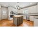 Bright kitchen boasts white cabinetry, stainless appliances, and center island at 5515 Punkintown Rd, Douglasville, GA 30135