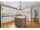 Spacious kitchen featuring white cabinets, granite counters, and a center island at 5515 Punkintown Rd, Douglasville, GA 30135