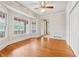 Sunlit living room with hardwood floors, large windows, and access to an enclosed porch at 5515 Punkintown Rd, Douglasville, GA 30135