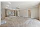 Expansive living room featuring a stone fireplace, large windows, and plush carpeting at 5515 Punkintown Rd, Douglasville, GA 30135