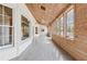 Long sunroom with wood ceiling and tile flooring showcases lots of natural light at 5515 Punkintown Rd, Douglasville, GA 30135