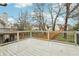 New wooden back deck overlooks the yard with trees, neighborhood and fence at 960 Sugar Meadow Dr, Sugar Hill, GA 30518