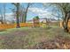 Large backyard features a wooden fence and play structure for outdoor fun at 960 Sugar Meadow Dr, Sugar Hill, GA 30518