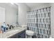 Bathroom featuring a granite vanity and a toilet with a patterned shower curtain at 960 Sugar Meadow Dr, Sugar Hill, GA 30518