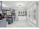 Eat-in kitchen featuring stainless steel appliances, gray cabinets, and ample counter space at 960 Sugar Meadow Dr, Sugar Hill, GA 30518