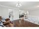 Cozy living room with wood floors, leading to open staircase and view of other rooms in the home at 960 Sugar Meadow Dr, Sugar Hill, GA 30518