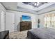 This main bedroom features tray ceilings, a ceiling fan, carpet floors, and natural light at 960 Sugar Meadow Dr, Sugar Hill, GA 30518