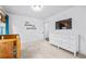 Bright bedroom with a white dresser, neutral carpet, and simple, stylish décor at 196 Wingo St, Norcross, GA 30071