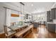 Open-concept kitchen and dining area with hardwood floors, modern appliances, and a farmhouse-style table at 196 Wingo St, Norcross, GA 30071