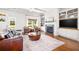 Inviting living room with hardwood floors, a fireplace, built-in shelving, and ample natural light at 196 Wingo St, Norcross, GA 30071