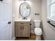 Bathroom featuring dark fixtures, wood vanity, and neutral decor at 2453 Paul Nw Ave, Atlanta, GA 30318