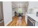 Dining room showcases hardwood flooring, modern lighting fixture with adjacent kitchen area at 2453 Paul Nw Ave, Atlanta, GA 30318