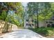 Charming curb appeal with new driveway and wooden fence surrounding the white two story home at 2453 Paul Nw Ave, Atlanta, GA 30318