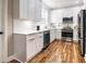 Modern kitchen featuring white cabinets, stainless steel appliances, and hardwood floors at 2453 Paul Nw Ave, Atlanta, GA 30318