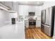 Modern kitchen features white cabinets, stainless steel appliances, and granite countertops at 2453 Paul Nw Ave, Atlanta, GA 30318