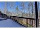 Wood deck with railings overlooking the wooded back yard of the home at 5030 New Chapel Hill Way, Cumming, GA 30041