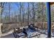 Wood deck with railings overlooking the wooded back yard, includes outdoor seating at 5030 New Chapel Hill Way, Cumming, GA 30041