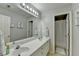 Modern bathroom featuring a double sink vanity, a large mirror, and a shower with a curtain at 5030 New Chapel Hill Way, Cumming, GA 30041