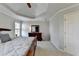 Relaxing bedroom featuring neutral walls, plush carpet, and trey ceiling at 5030 New Chapel Hill Way, Cumming, GA 30041