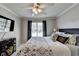 Bedroom with a large window, mounted TV, and neutral paint at 5030 New Chapel Hill Way, Cumming, GA 30041