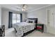 Bedroom featuring a patterned comforter, large window, and colorful night stand at 5030 New Chapel Hill Way, Cumming, GA 30041