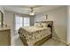 Cozy bedroom with a floral-patterned bedspread and a ceiling fan at 5030 New Chapel Hill Way, Cumming, GA 30041